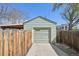This garage features a single car garage door and a fenced in yard at 6819 Reno Dr, Arvada, CO 80002