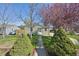 View of the attractive house, with a tidy front yard, landscaping, and inviting entrance at 6819 Reno Dr, Arvada, CO 80002