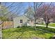 Exterior view of a well-maintained home with a green lawn, driveway, and plenty of shade trees at 6819 Reno Dr, Arvada, CO 80002