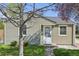Charming single-story home with light-green siding, a well-manicured lawn, and a welcoming front door at 6819 Reno Dr, Arvada, CO 80002