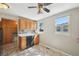 Eat-in kitchen features wood cabinets, a black dishwasher, and a sunny window at 6819 Reno Dr, Arvada, CO 80002