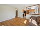 Open-concept living area with hardwood flooring, seamlessly flowing into the kitchen and dining spaces at 6819 Reno Dr, Arvada, CO 80002