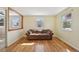 Bright living room featuring hardwood floors, natural light, and a comfortable seating area at 6819 Reno Dr, Arvada, CO 80002
