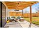 Covered patio with outdoor furniture, a built in fire pit, and privacy fence at 6844 W 69Th Pl, Arvada, CO 80003