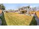Large grassy backyard with multi level patios, mature trees, and privacy fence at 6844 W 69Th Pl, Arvada, CO 80003