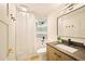 Bright bathroom with light wood cabinets, contrasting hardware and a shower and tub combination at 6844 W 69Th Pl, Arvada, CO 80003