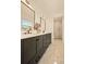 Modern bathroom showcasing a double vanity with black fixtures and a glass-enclosed shower at 6844 W 69Th Pl, Arvada, CO 80003