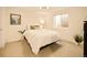 This bedroom has neutral walls, and carpet, and has a ceiling fan with a window at 6844 W 69Th Pl, Arvada, CO 80003