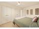 Bright bedroom with a ceiling fan, neutral walls, and lots of closet space at 6844 W 69Th Pl, Arvada, CO 80003