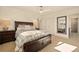 Spacious bedroom featuring a ceiling fan, large bed, and ensuite bathroom with shower at 6844 W 69Th Pl, Arvada, CO 80003