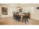 Bright dining area featuring natural light, wood table, and seating for eight at 6844 W 69Th Pl, Arvada, CO 80003