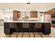 Bright kitchen features a large island, granite countertops, and modern lighting at 6844 W 69Th Pl, Arvada, CO 80003
