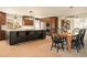 Open concept kitchen with island seating, pendant lighting, and seamless dining area at 6844 W 69Th Pl, Arvada, CO 80003