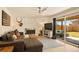 Open-concept living room flows onto the patio with outdoor seating and gas firepit at 6844 W 69Th Pl, Arvada, CO 80003