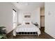 Serene bedroom with a white metal bed, minimalist decor, and ample natural light, creating a peaceful retreat at 1898 S Bannock St # 510, Denver, CO 80223