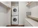 Closet with stacked washer and dryer, along with shelving for organized storage and clothing at 1898 S Bannock St # 510, Denver, CO 80223