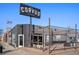Modern coffee roaster building with black painted exterior, stylish outdoor seating and minimalist signage at 1898 S Bannock St # 510, Denver, CO 80223