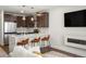Modern kitchen with stainless steel appliances, sleek cabinetry, quartz countertop, and seating at the island at 1898 S Bannock St # 510, Denver, CO 80223
