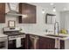 A modern kitchen features stainless steel appliances, white subway tiles, and pristine white countertops at 1898 S Bannock St # 510, Denver, CO 80223