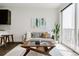 Bright living room featuring a comfortable sofa, modern art, and a coffee table, creating a cozy and inviting space at 1898 S Bannock St # 510, Denver, CO 80223