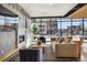 Bright living room with modern fireplace, stylish furniture, and large windows with city views at 1898 S Bannock St # 510, Denver, CO 80223