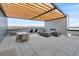 Expansive rooftop deck with a fireplace, dining table, lounge chairs and stunning views of the surrounding landscape at 1898 S Bannock St # 510, Denver, CO 80223