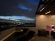 Chic rooftop deck with modern lighting, outdoor fireplace, and stunning skyline view at 1898 S Bannock St # 510, Denver, CO 80223
