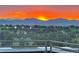 Panoramic sunset view overlooking a lush green golf course and distant mountains at 1898 S Bannock St # 510, Denver, CO 80223