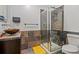 Bathroom with glass shower, earth-tone tile, modern fixtures, and ample counter space at 2000 Arapahoe St # 1, Denver, CO 80205
