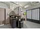 Modern bathroom featuring dark vanity, vessel sink, geometric floors, and decorative screen at 2000 Arapahoe St # 1, Denver, CO 80205