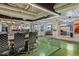 Conference room with glass walls, modern lighting, and view into open office with kitchen and pool table at 2000 Arapahoe St # 1, Denver, CO 80205