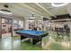 Spacious game room features a pool table, cool light fixtures, and comfortable seating area at 2000 Arapahoe St # 1, Denver, CO 80205