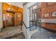 Building lobby featuring textured walls, a copper elevator, and a brick mail area at 2000 Arapahoe St # 1, Denver, CO 80205