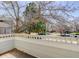 Balcony view featuring white wood railings and mature trees lining the street at 3951 S Carson St # D, Aurora, CO 80014