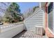 Cozy balcony view with wood railings, neutral siding, and exterior storage at 3951 S Carson St # D, Aurora, CO 80014