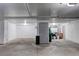 Unfinished basement with concrete floors, bright lighting, and ample space at 3951 S Carson St # D, Aurora, CO 80014