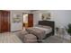 Staged primary bedroom featuring a queen bed, two ottomans, and ensuite bathroom at 3951 S Carson St # D, Aurora, CO 80014