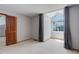 Bright bedroom with a large window, neutral carpeting and gray accents at 3951 S Carson St # D, Aurora, CO 80014