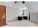 A carpeted bedroom featuring an angled ceiling, fan, and a desk by the window at 3951 S Carson St # D, Aurora, CO 80014