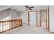 A bedroom near wooden railings features a ceiling fan and doorways to other rooms at 3951 S Carson St # D, Aurora, CO 80014