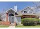 Charming two-story home featuring brick accents, landscaped yard and light blue siding at 3951 S Carson St # D, Aurora, CO 80014