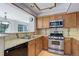 Updated kitchen featuring light countertops and plenty of storage in natural wood cabinets at 3951 S Carson St # D, Aurora, CO 80014