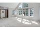 Sunlit living room with high ceilings, large windows and neutral color palette at 3951 S Carson St # D, Aurora, CO 80014