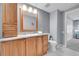 Well-lit bathroom featuring a vanity with granite countertops, storage and toilet at 7077 S Knolls Way, Centennial, CO 80122