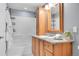 Well-lit bathroom featuring a vanity with granite countertops, storage and shower/tub combination at 7077 S Knolls Way, Centennial, CO 80122