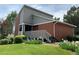 Stylish multi-story exterior with brick accents, lush landscaping, and covered entrance at 7077 S Knolls Way, Centennial, CO 80122
