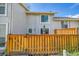 Home exterior with wooden fence and a decorative wreath on the front door at 7077 S Knolls Way, Centennial, CO 80122