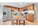Well-equipped kitchen with granite countertops, stainless steel appliances, and stylish stools at the island at 7077 S Knolls Way, Centennial, CO 80122