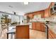 An open kitchen concept with island seating, stainless appliances and sliding door access at 7077 S Knolls Way, Centennial, CO 80122