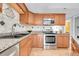 Charming kitchen with stainless steel appliances and granite countertops at 7077 S Knolls Way, Centennial, CO 80122